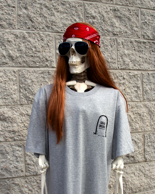 Skeleton wearing grey graphic T-shirt with ironic design by PISTEIK